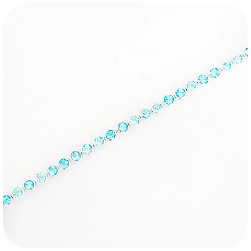 Round cut Swiss Blue Topaz Tennis Bracelet in Sterling Silver